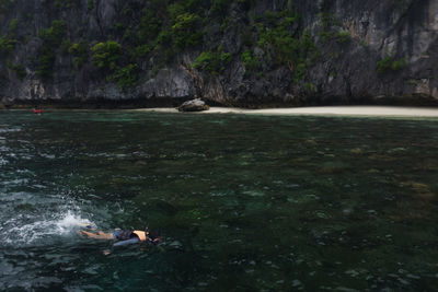 Scenic view of sea against rock formation