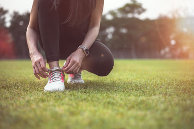 Low section of woman with ball on grass