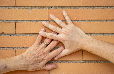 Cropped hands on wall