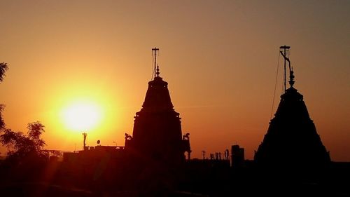 Silhouette of built structure at sunset
