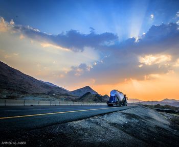 Car on road against sky during sunset