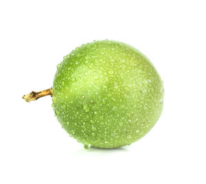 Close-up of wet apple against white background