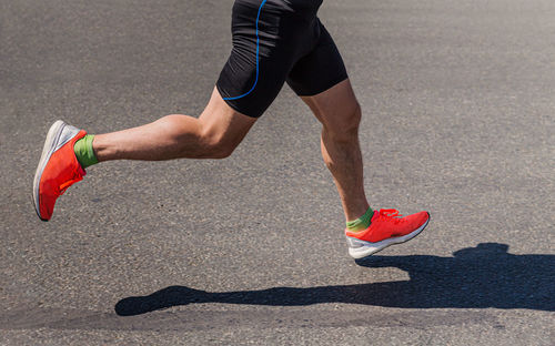Legs runner athlete running on marathon