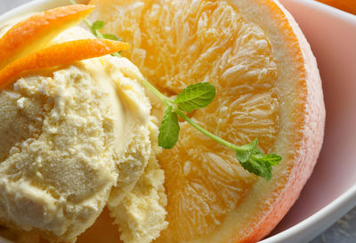 Close-up of orange slice and ice cream