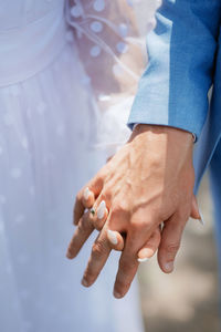 Close-up of couple holding hands