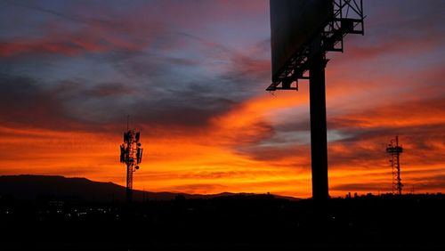 Silhouette crane against sky during sunset