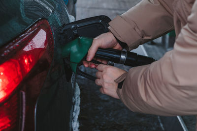 Cropped hand of man holding camera