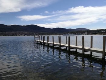 Pier over lake against sky