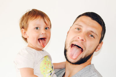 Portrait of happy friends against white background