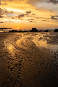 Scenic view of beach against sky during sunset