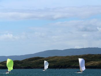 Boat sailing in sea against sky