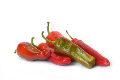 Close-up of chili peppers against white background