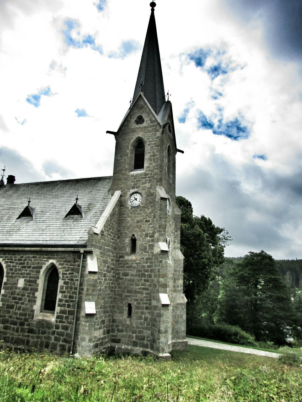 architecture, building exterior, built structure, religion, church, sky, spirituality, place of worship, low angle view, history, cloud - sky, tower, old, tree, cross, cathedral, cloud, clock tower