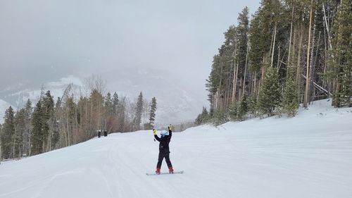 Full length of person walking on snow covered land