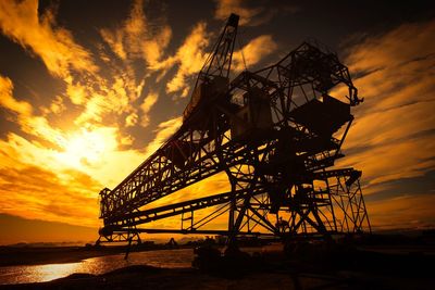 Low angle view of silhouette bridge against sky during sunset