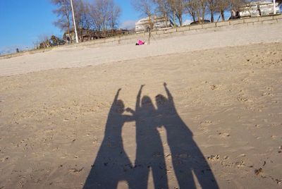 Shadow of hands on sand
