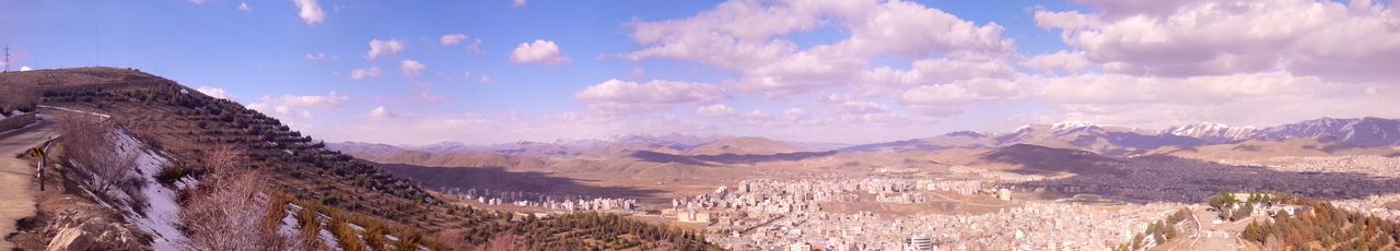 Scenic view of mountains against cloudy sky