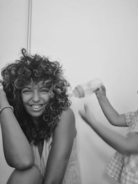 Portrait of woman holding camera at home