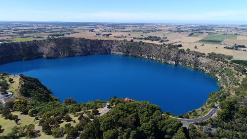 High angle view of trees by lake against sky