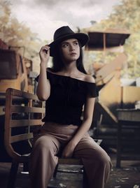 Young woman sitting on bench