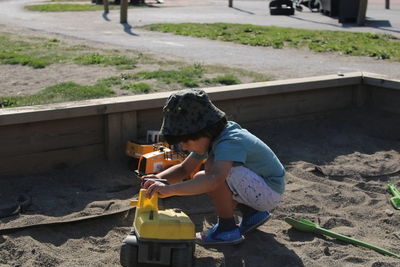 Portrait of boy playing with toy car