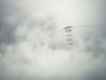 Low angle view of telephone pole against sky