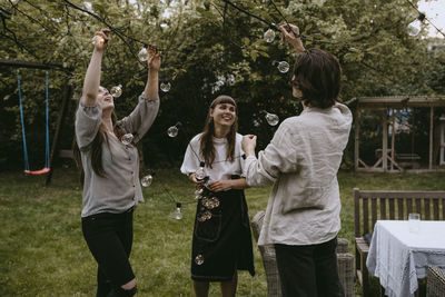 Group of people against plants