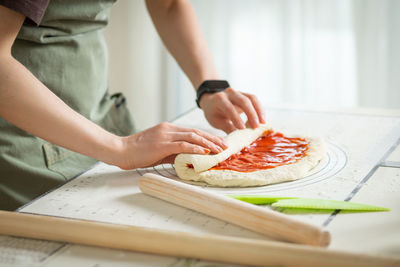 Midsection of man preparing food on table