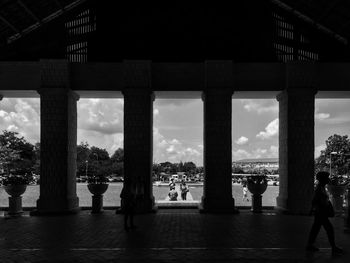 People seen through architectural columns