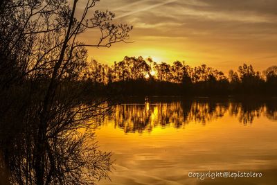 Scenic view of lake at sunset