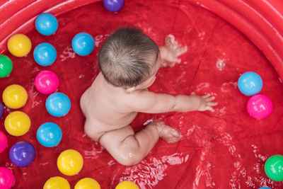 High angle view of child playing with balloons