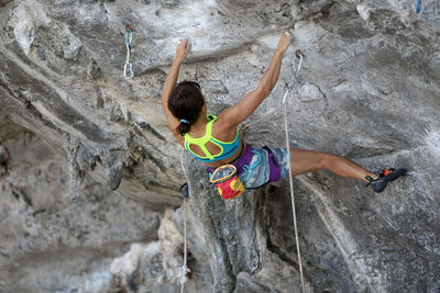 High angle view of man climbing on rock