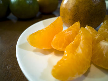 Close-up of orange slice in plate on table