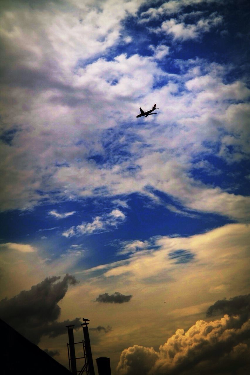 airplane, air vehicle, flying, sky, low angle view, cloud - sky, mode of transport, transportation, mid-air, cloudy, public transportation, cloud, commercial airplane, built structure, travel, aircraft wing, architecture, aircraft, journey, silhouette