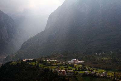 High angle view of townscape by mountain against sky