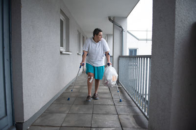 Rear view of man walking on steps