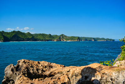 Scenic view of sea against clear blue sky