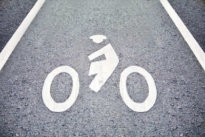 High angle view of bicycle lane sign on road