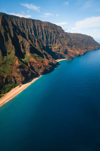 Scenic view of sea and mountains against sky