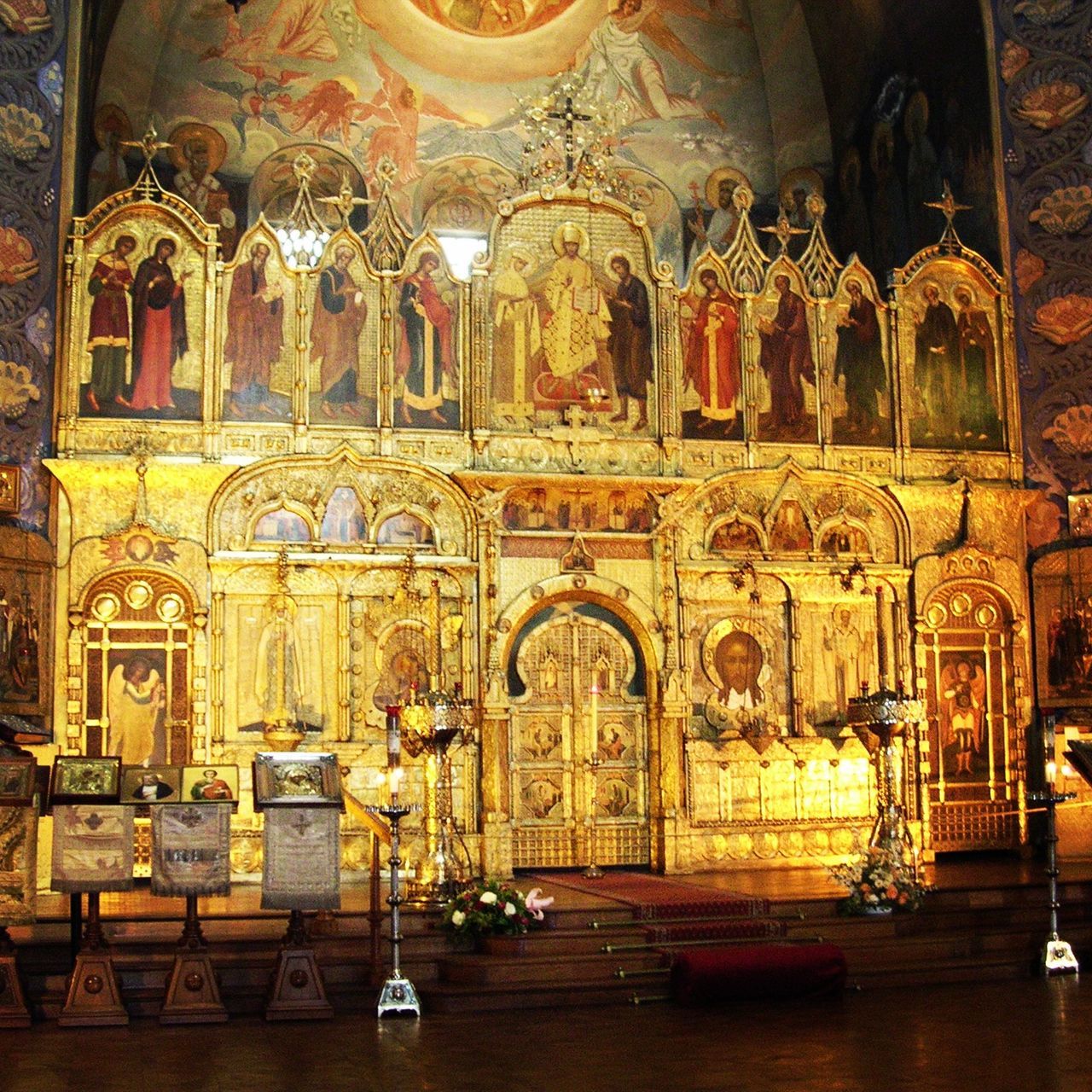 indoors, place of worship, religion, art and craft, church, spirituality, architecture, art, built structure, creativity, illuminated, table, human representation, no people, window, interior, ornate, arch