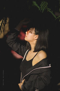 Side view of woman dancing at music concert