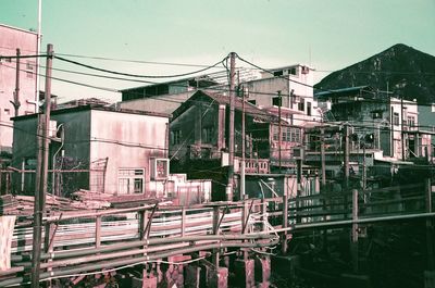 Construction site by buildings in city against sky