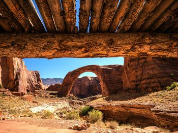 Scenic view of natural arch at rainbow bridge national monument on sunny day