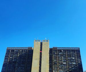 Low angle view of modern building against clear blue sky