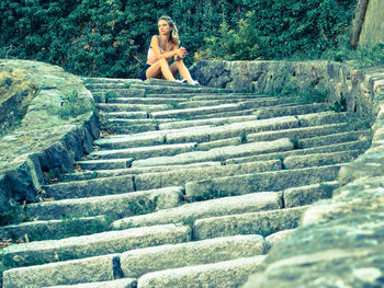 Woman sitting on stairs