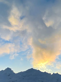 Low angle view of snowcapped mountains against sky during sunset