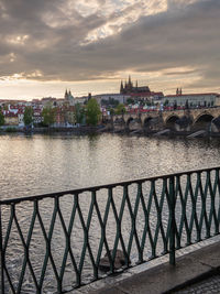 Bridge over river against buildings in city