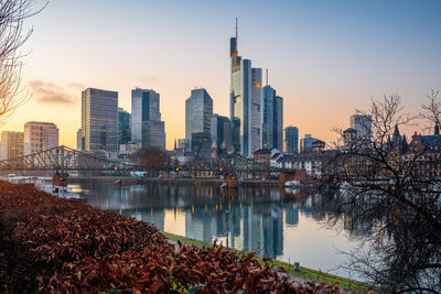 Reflection of buildings in city against sky