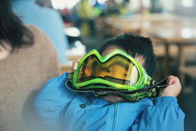 Portrait of cute boy holding ski goggles