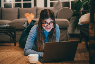 Young woman using laptop at home